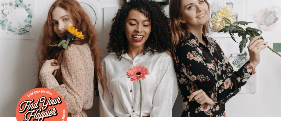 three girls stand with flower stems